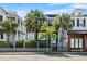 Charming two-story home featuring a small balcony, palm trees, and beautiful landscaping at 167 Spring St # A/B, Charleston, SC 29403