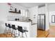 A compact, efficient kitchen featuring stainless steel appliances and bar stool seating at 167 Spring St # A/B, Charleston, SC 29403