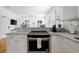 Bright kitchen with stone countertops, stainless steel oven, and classic white cabinets at 167 Spring St # A/B, Charleston, SC 29403