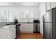 Well-lit modern kitchen with white cabinets, stainless steel appliances, and open window at 167 Spring St # A/B, Charleston, SC 29403