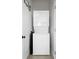 Laundry area featuring a stacked washer and dryer unit and a clean and organized space at 167 Spring St # A/B, Charleston, SC 29403