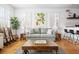 Cozy living room featuring hardwood floors, a comfortable couch, and natural light at 167 Spring St # A/B, Charleston, SC 29403