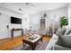 Cozy living room featuring hardwood floors, a comfortable couch, and natural light at 167 Spring St # A/B, Charleston, SC 29403