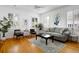 Bright living room featuring hardwood floors, large windows, and a comfortable seating area at 167 Spring St # A/B, Charleston, SC 29403