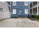 Concrete parking area beside a blue two-story house with white trim and a walkway at 167 Spring St # A/B, Charleston, SC 29403