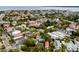 An aerial view shows a neighborhood with diverse homes and tree cover near the waterfront at 18 Logan St, Charleston, SC 29401