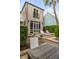 Backyard patio with a pool, lounge chairs, outdoor dining, a lush green privacy hedge, and mature trees at 18 Logan St, Charleston, SC 29401