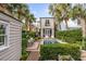 Beautiful backyard with a pool, a seating area, lush landscaping, and a charming outbuilding at 18 Logan St, Charleston, SC 29401