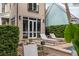 A cozy backyard with a small pool, lounge chairs, lush greenery, and french doors to the home's interior at 18 Logan St, Charleston, SC 29401