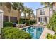 Inviting backyard pool with palm trees and patio furniture creating a private outdoor oasis at 18 Logan St, Charleston, SC 29401