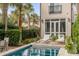 Private backyard pool surrounded by lush greenery, lounge chairs, and palm trees at 18 Logan St, Charleston, SC 29401