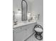 Bright bathroom featuring tiled floors, neutral paint, and a modern vanity with black accents at 18 Logan St, Charleston, SC 29401