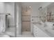Bright bathroom features a stand up shower, double vanity with modern fixtures, and neutral tiling at 18 Logan St, Charleston, SC 29401