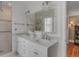 Bright bathroom features a stand up shower, double vanity with modern fixtures, and neutral tiling at 18 Logan St, Charleston, SC 29401