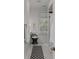 Charming bathroom featuring black and white tile flooring, a stylish vanity, and a window with natural light at 18 Logan St, Charleston, SC 29401