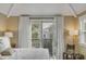 Light-filled bedroom with French doors to a private balcony at 18 Logan St, Charleston, SC 29401