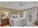 Cozy bedroom with vaulted ceilings, white linens, and balcony access at 18 Logan St, Charleston, SC 29401