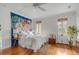 Bright bedroom featuring hardwood floors, neutral paint, windows providing abundant natural light at 18 Logan St, Charleston, SC 29401