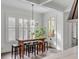 Eat-in kitchen area with a rustic wooden table, seating for six, and natural light from shuttered windows at 18 Logan St, Charleston, SC 29401