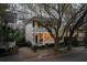 Charming two-story home with a welcoming front porch, and a well-manicured yard at 18 Logan St, Charleston, SC 29401