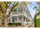 Stunning two-story home with double porches, white columns, and manicured landscaping at 18 Logan St, Charleston, SC 29401