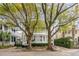 Charming home with double porches nestled behind mature trees on a picturesque street at 18 Logan St, Charleston, SC 29401