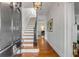 Welcoming foyer with hardwood floors, staircase, and decorative lighting at 18 Logan St, Charleston, SC 29401