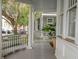 Charming front porch with white columns, classic railings, and a potted plant adding a touch of greenery at 18 Logan St, Charleston, SC 29401