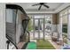 Spacious indoor golf room with putting green, golf simulator net, and tiled floor at 18 Logan St, Charleston, SC 29401