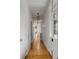 Long hallway with hardwood floors, white walls, and decorative light fixtures overhead at 18 Logan St, Charleston, SC 29401