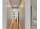 Hallway featuring hardwood floors and white trim, leading to a bright living space with stylish decor at 18 Logan St, Charleston, SC 29401
