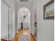 Hallway with wooden floors, white trim, and arched doorway at 18 Logan St, Charleston, SC 29401