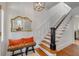 Hallway features hardwood floors, staircase, and a decorative mirror and bench at 18 Logan St, Charleston, SC 29401