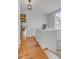 Bright upstairs hallway with white walls, hardwood floors, and a decorative light fixture at 18 Logan St, Charleston, SC 29401