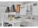Bright kitchen featuring a large island with seating, stainless steel appliances, and stylish pendant lights at 18 Logan St, Charleston, SC 29401