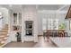 Kitchen area showcasing stainless steel double ovens, white cabinets, a wine cooler, and a breakfast table at 18 Logan St, Charleston, SC 29401