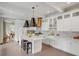 Elegant white kitchen with marble countertops, stainless steel appliances, and a large island at 18 Logan St, Charleston, SC 29401