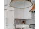 Bright kitchen with white cabinets and marble countertops, featuring a stainless steel sink and fixtures at 18 Logan St, Charleston, SC 29401