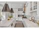 Spacious kitchen features a large island, farmhouse sink, stainless appliances, and modern lighting at 18 Logan St, Charleston, SC 29401