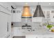 Bright, modern kitchen featuring white cabinets, a center island, and stainless steel appliances at 18 Logan St, Charleston, SC 29401