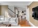 Inviting living room showcases hardwood floors, white sofa, and open access to a modern kitchen at 18 Logan St, Charleston, SC 29401