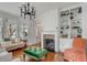 Bright living room with hardwood floors, fireplace, and custom built-in shelving at 18 Logan St, Charleston, SC 29401