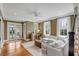 Spacious living room featuring hardwood floors, natural light, and access to an outdoor patio at 18 Logan St, Charleston, SC 29401