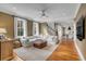 Bright living room with large windows, hardwood floors, and a comfortable white sectional sofa at 18 Logan St, Charleston, SC 29401