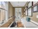 Functional home office with a Peloton, built-in desk, natural light, and displayed diplomas at 18 Logan St, Charleston, SC 29401