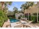 Private backyard oasis with pool, lounging area, detached shed, and lush landscaping at 18 Logan St, Charleston, SC 29401