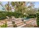 Contemporary backyard with a rectangular pool, lounge chairs, and lush greenery at 18 Logan St, Charleston, SC 29401