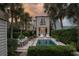 Private backyard with pool, outdoor dining, lush landscaping, and modern outdoor lighting at 18 Logan St, Charleston, SC 29401