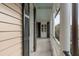 Inviting porch view featuring classic columns, black shutters, and detailed trim at 18 Logan St, Charleston, SC 29401