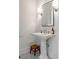 Stylish powder room featuring pedestal sink and mosaic tile floor at 18 Logan St, Charleston, SC 29401